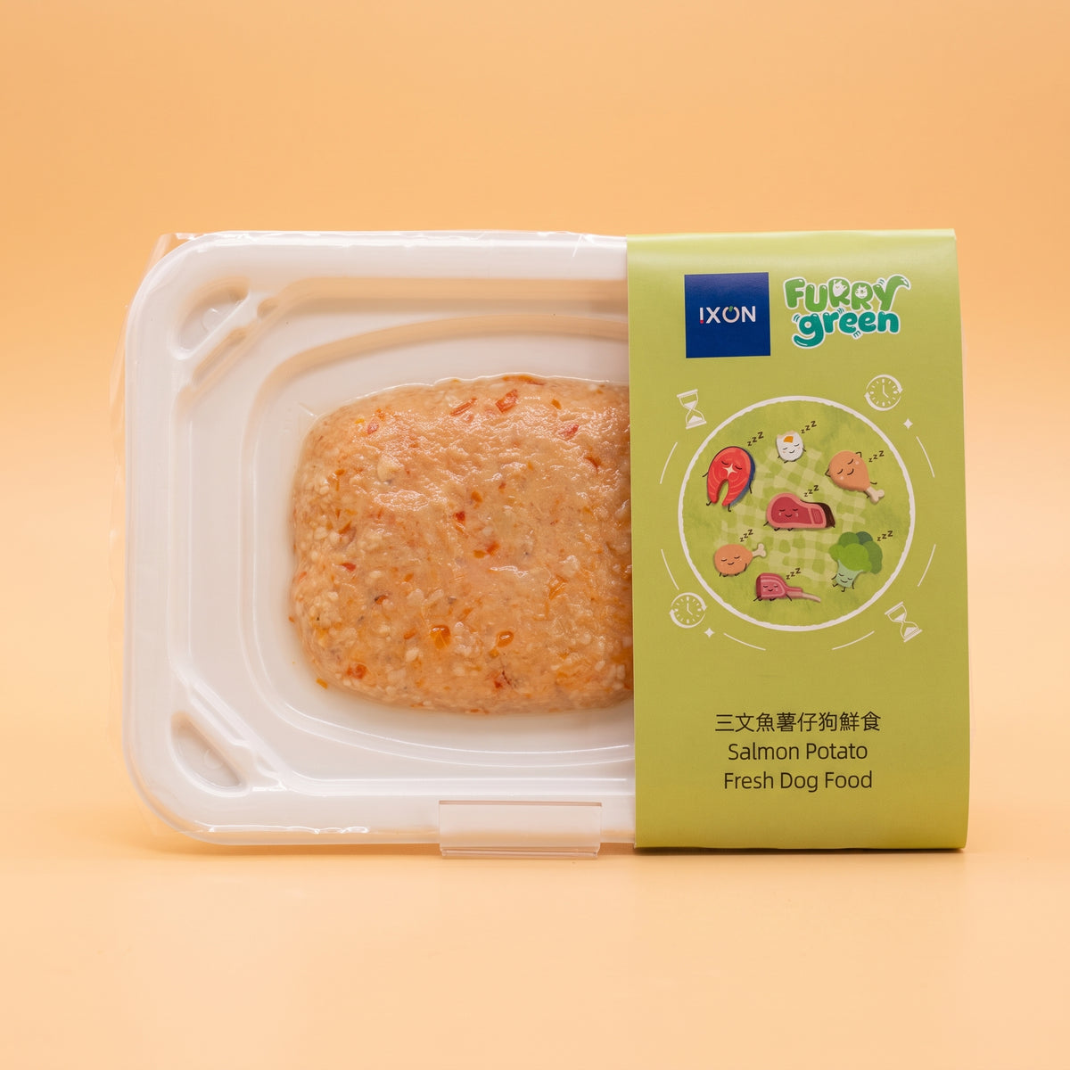 A package of IXON Furry Green Salmon Potato Fresh Dog Food, showing the prepared wet food inside a clear plastic tray with a light green label, set against a solid peach background.